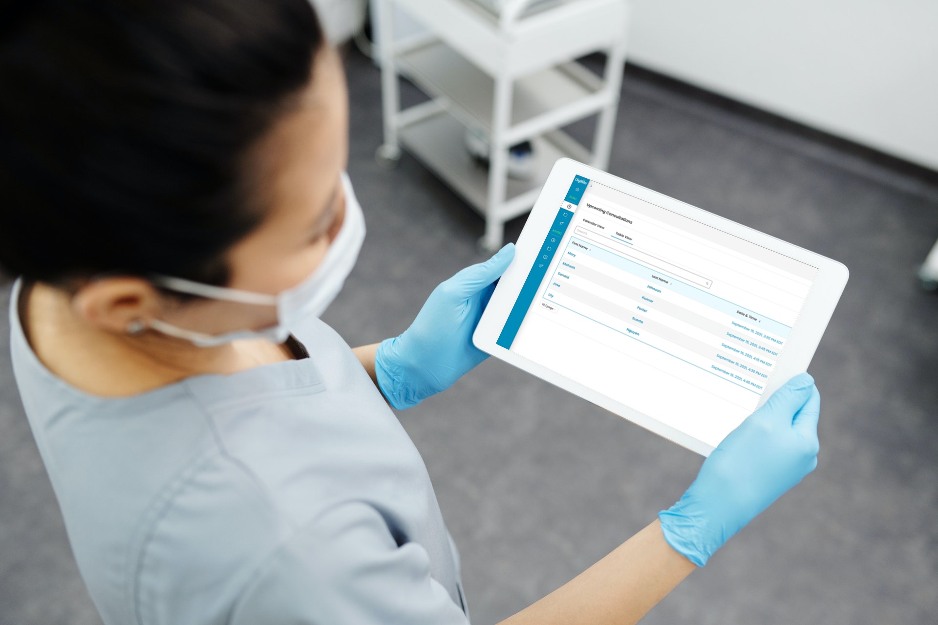 Dentist standing looking down at tablet. On tablet screen is the DigiBite admin portal